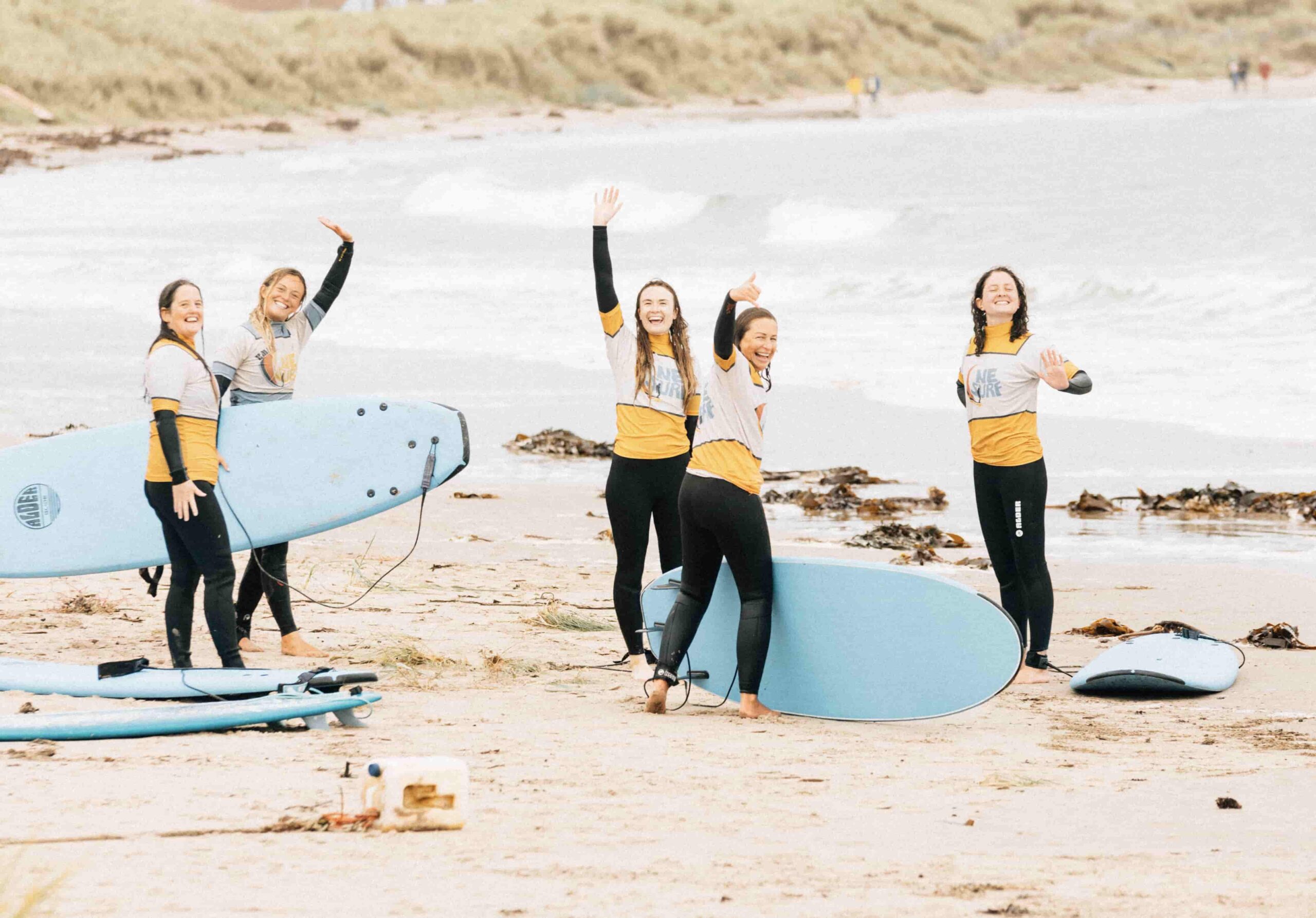 Happy surfers on the beach at beadnell